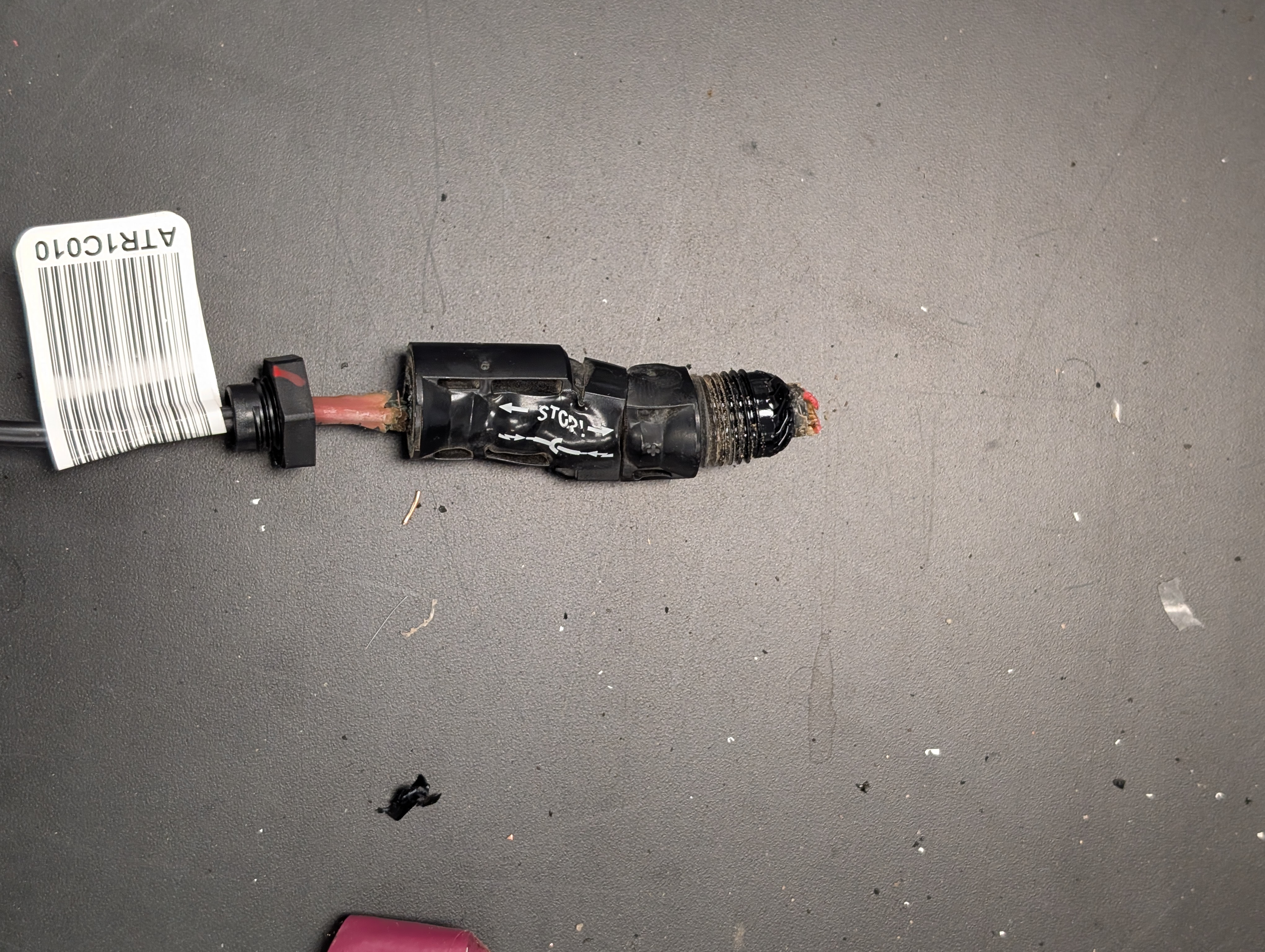 A failed PV connector with a test tracking barcode.