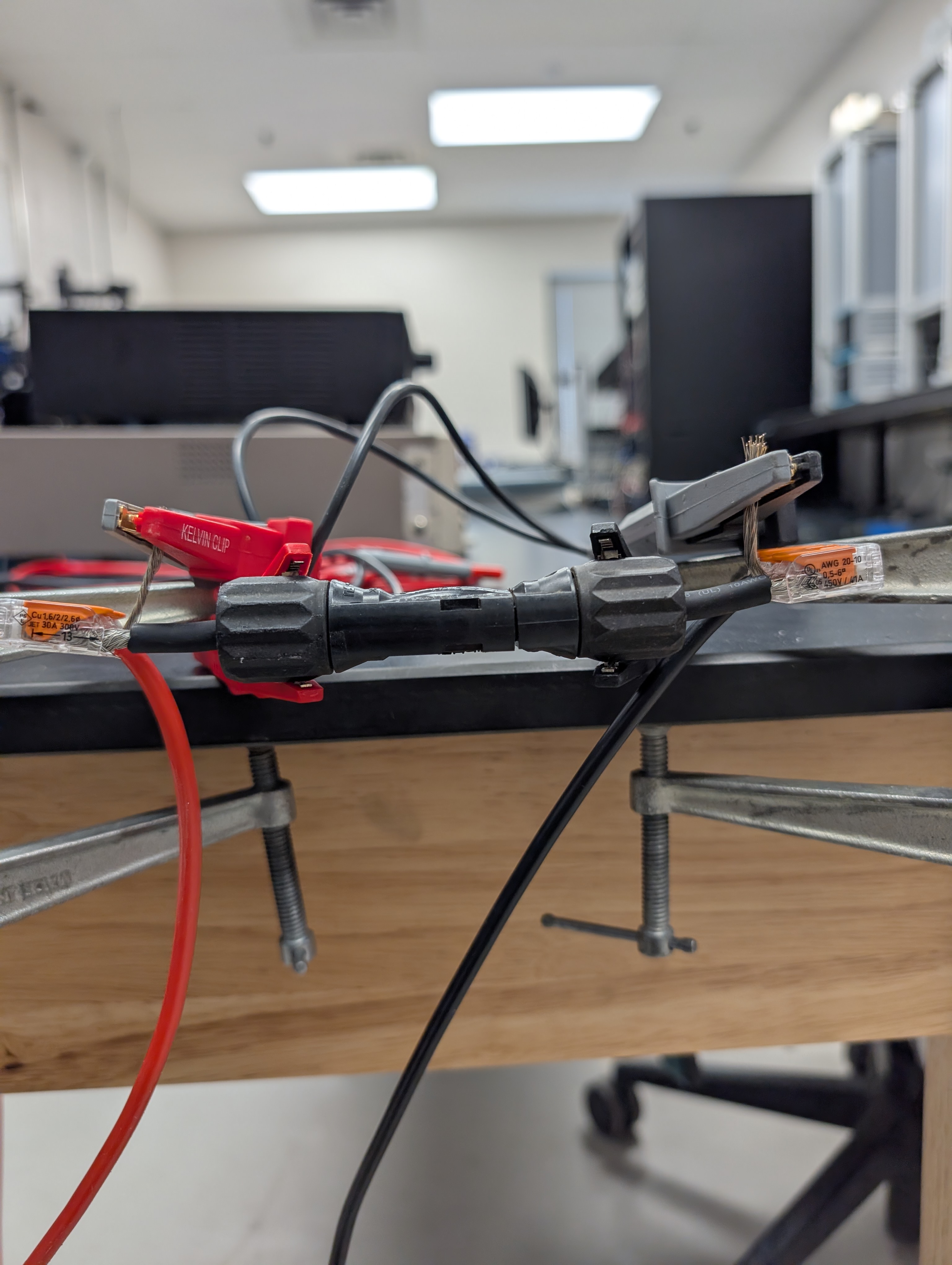 PV connector held in Kelvin clips for four-wire resistance measurement.
